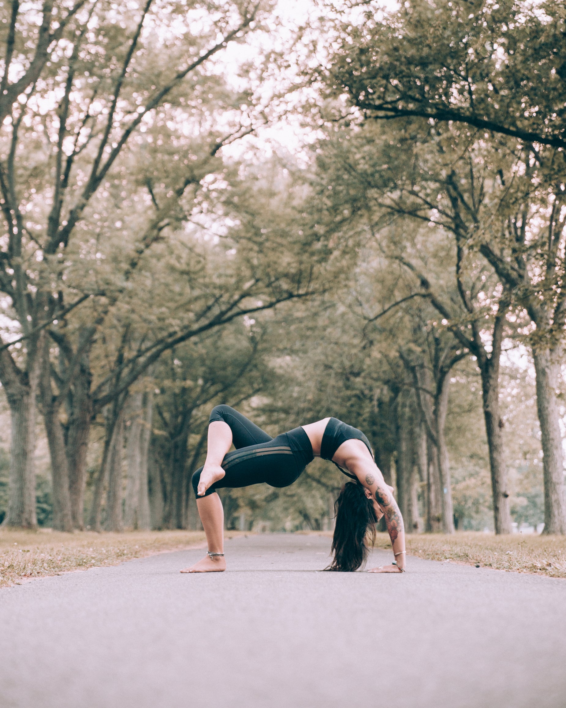 "Woman in bridge pose with hips lifted outdoors"